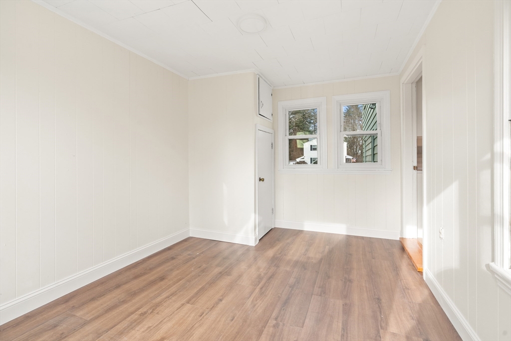 10 Dulgarian Terrace, Unit 10 Chelmsford, MA 01824 - Photo 16 of 18 an empty room with wooden floor and windows