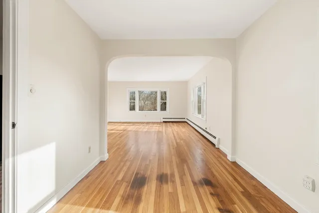 a view of a room with wooden floor and brick walls