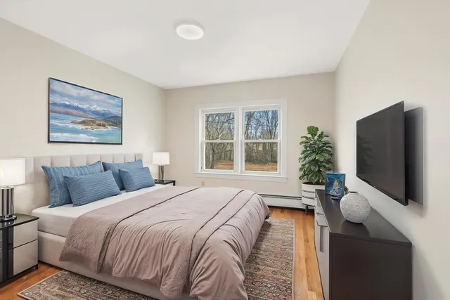 a bedroom with a large bed and a flat screen tv