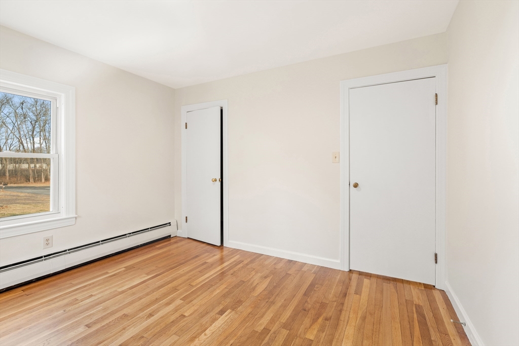10 Dulgarian Terrace, Unit 10 Chelmsford, MA 01824 - Photo 9 of 18 an empty room with wooden floor and windows