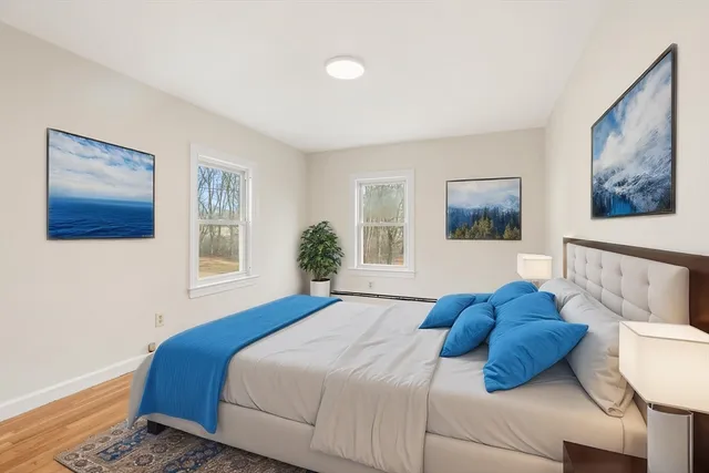 a bedroom with a bed couch and window