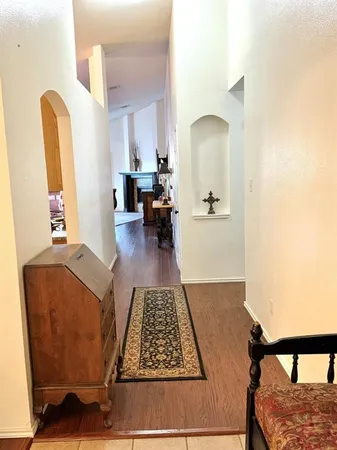 a living room with furniture rug and a table
