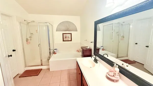 a spacious bathroom with a tub shower and sink