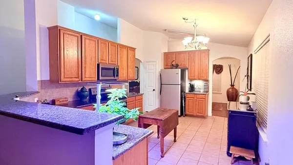 a kitchen with refrigerator cabinets and wooden floor