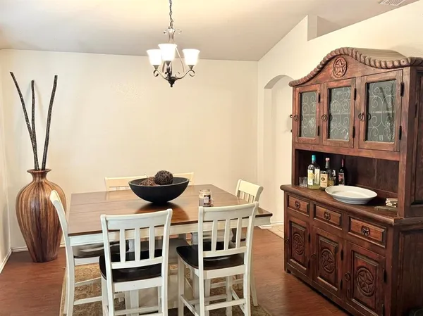 a view of a dining room with furniture wooden floor and chandelier