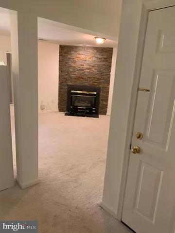 a view of empty room with a fireplace