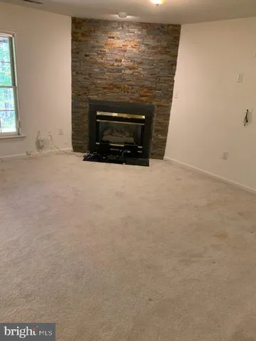 a view of empty room with a fireplace