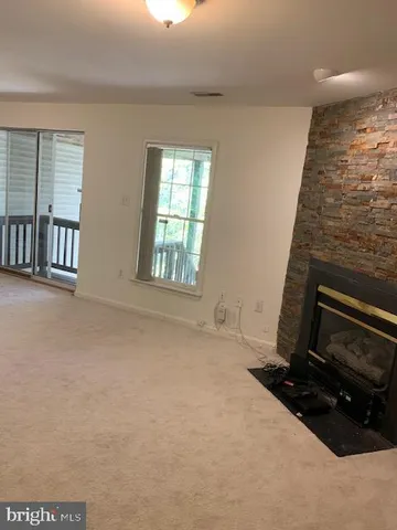 a view of an empty room with a fireplace