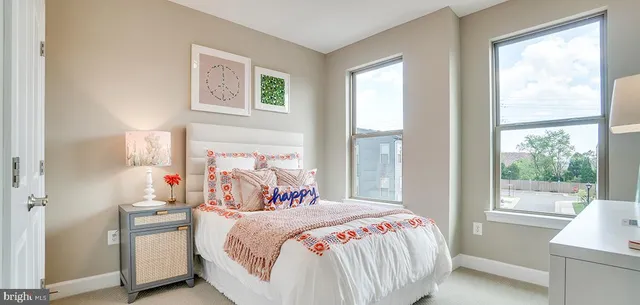 a bedroom with a bed and a large window with the outer view