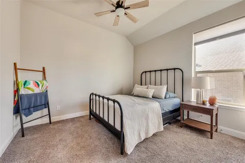 a spacious bedroom with a bed and a window