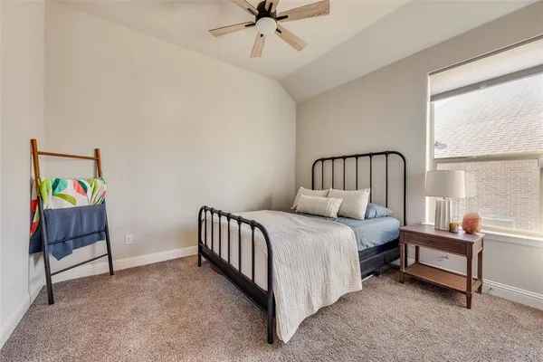 a spacious bedroom with a bed and a window