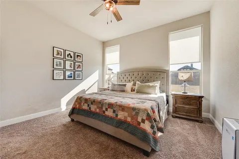 a bed sitting in a bedroom next to a window