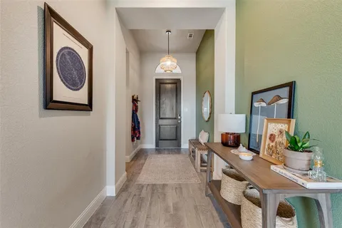 a hallway with a sink and a mirror