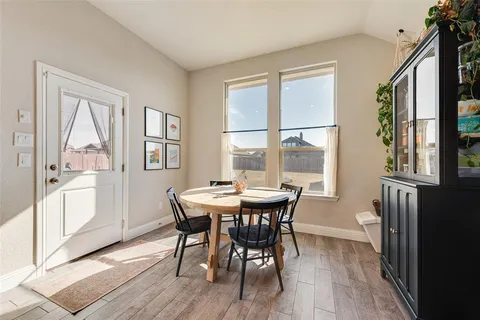a view of a dining room with furniture and window