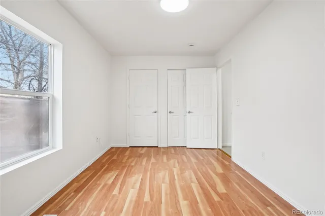 a view of a room with wooden floor and small space