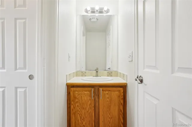 a bathroom with a granite countertop sink and a mirror