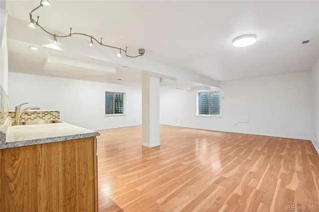 a view of a livingroom with wooden floor and staircase