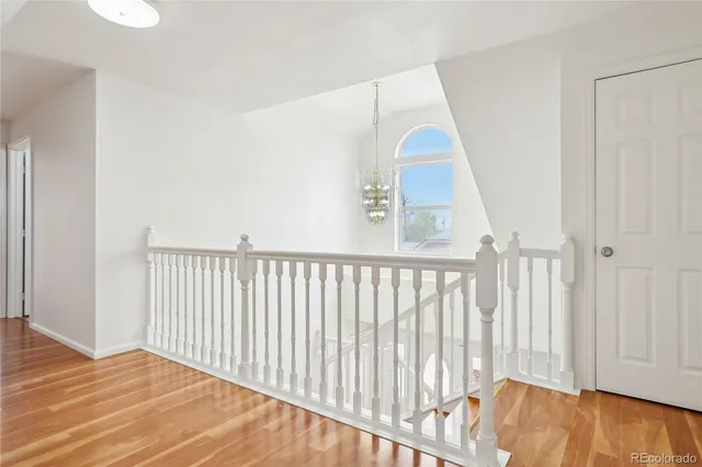a view of a bedroom with wooden floor