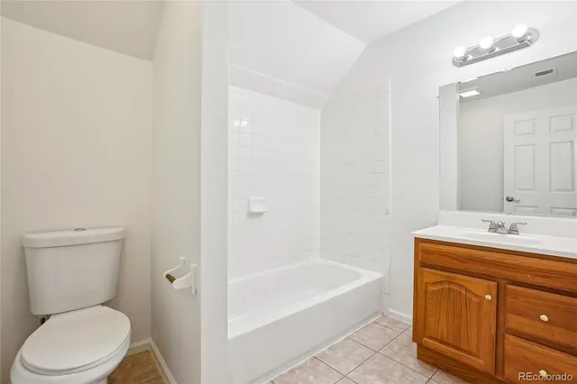 a bathroom with a sink toilet vanity and bathtub