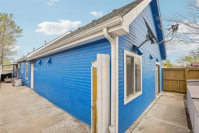 a view of a house with wooden fence