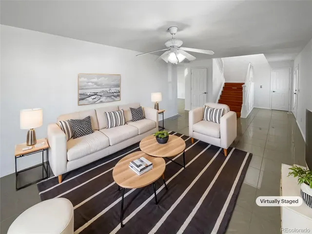 a living room with furniture and a lamp