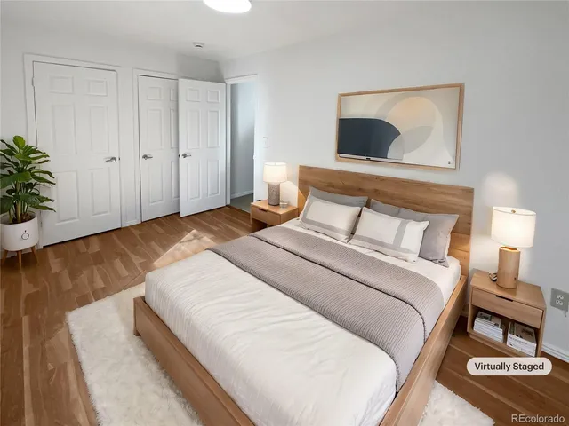 a bedroom with a bed and a potted plant