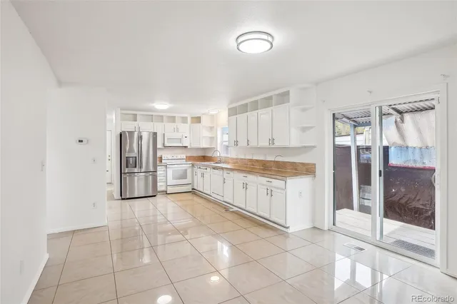 a large kitchen with cabinets and stainless steel appliances
