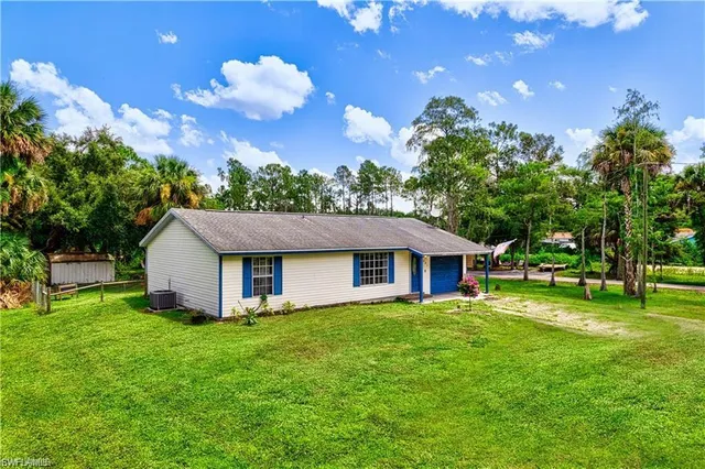 a front view of house with an outdoor space and garden