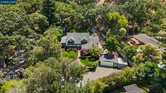 an aerial view of a house with yard swimming pool and outdoor seating