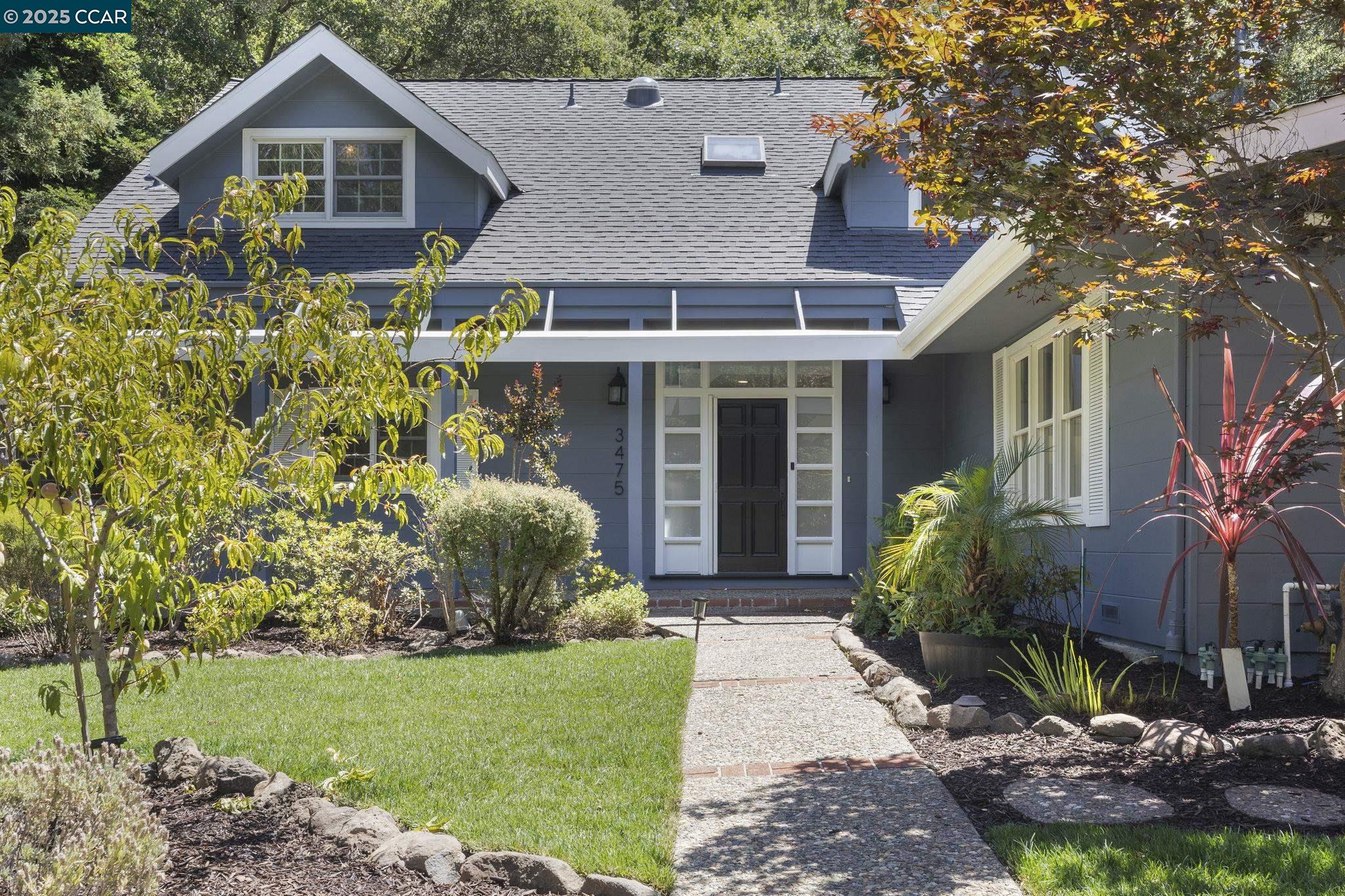 a front view of a house with garden