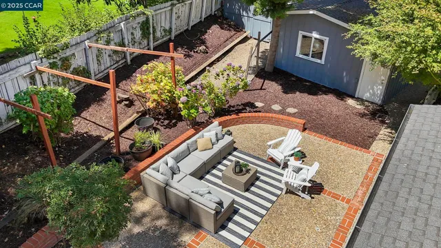 an aerial view of a house with garden space and street view
