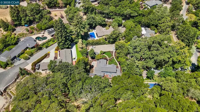 an aerial view of a house with a yard and garden