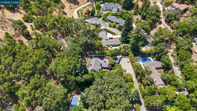 an aerial view of a house with a yard