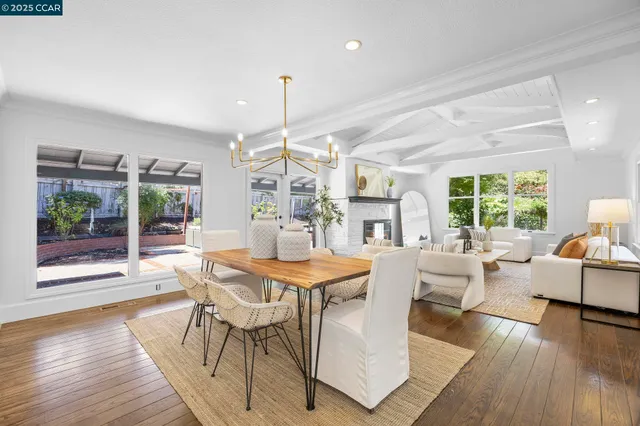 a view of a dining room with furniture wooden floor and chandelier