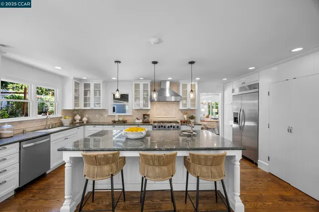 a kitchen with refrigerator and cabinets