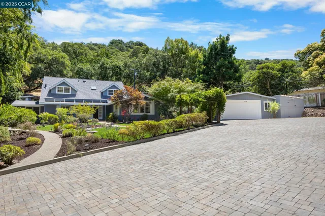 a front view of a house with a garden