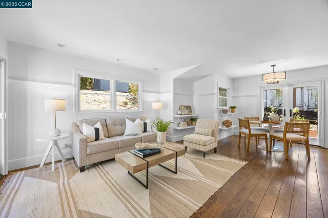 a living room with lots of furniture wooden floor and a rug