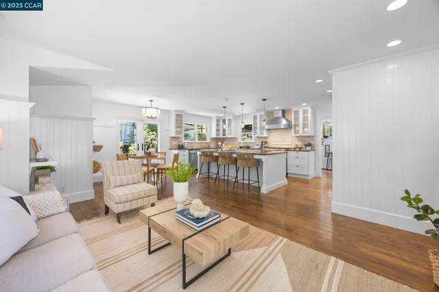 a living room with furniture and kitchen view