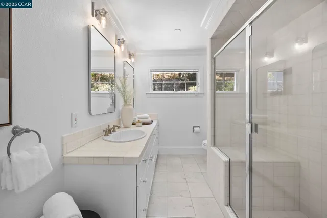 a bathroom with a sink and mirror with toilet