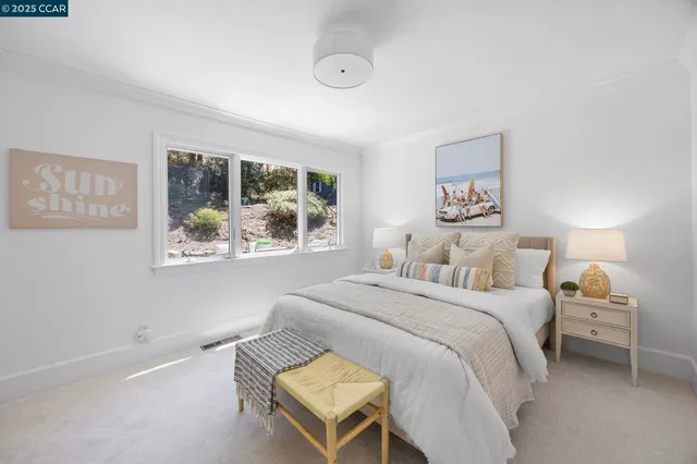 a bedroom with a bed and a painting on the wall