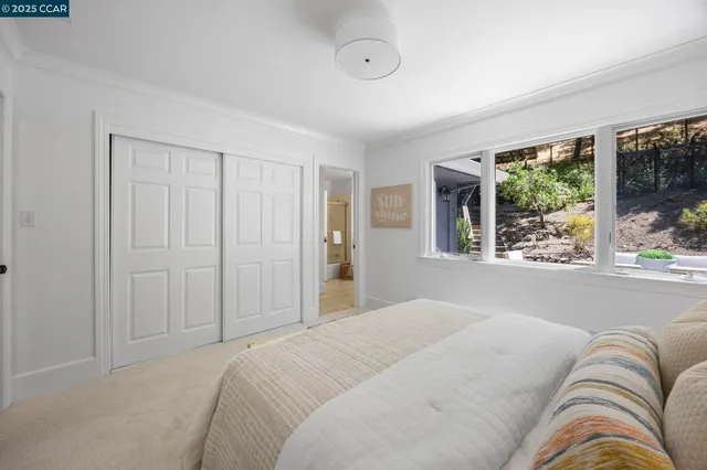 a bedroom with a bed and glass window