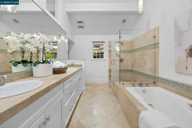 a spacious bathroom with a bathtub sink and mirror