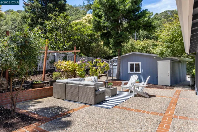 a view of a backyard with sitting area