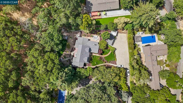 an aerial view of a house with a yard and garden