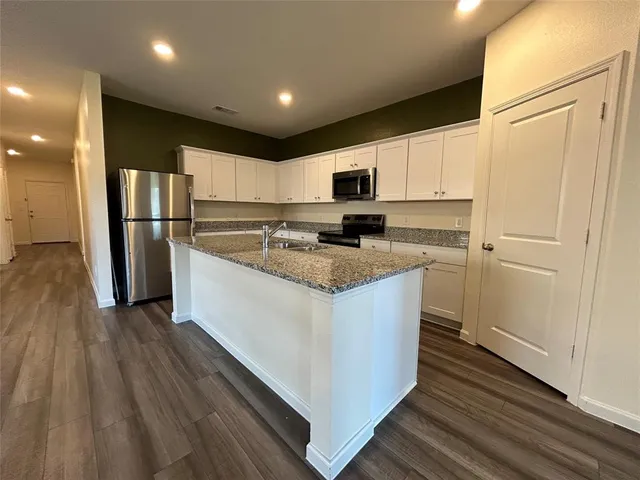 a view of kitchen with wooden floor