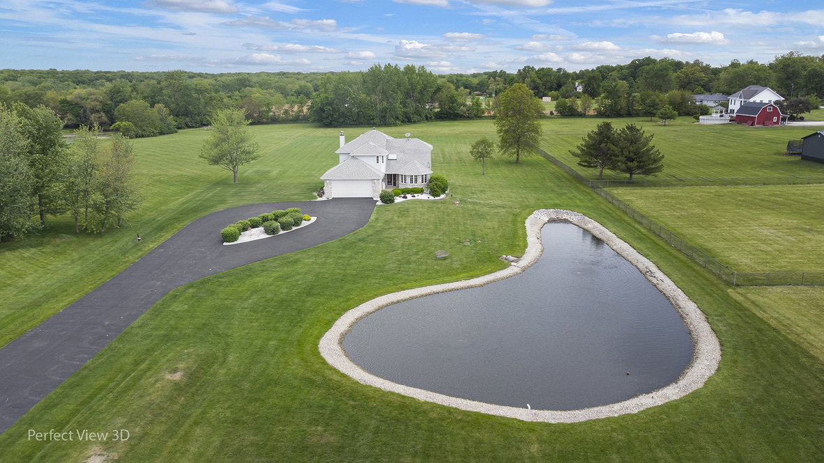 an aerial view of a house with a yard