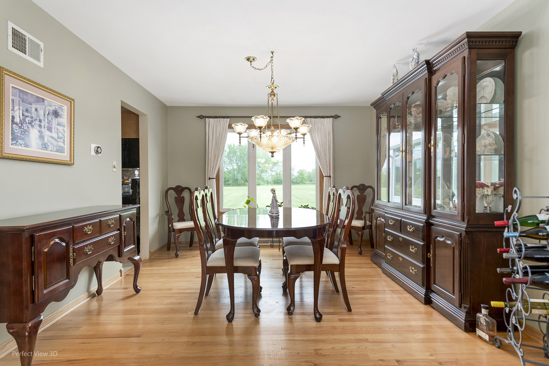 13836 West Joliet Road Manhattan, IL 60442 - Photo 14 of 25 a view of a dining room with furniture window and wooden floor