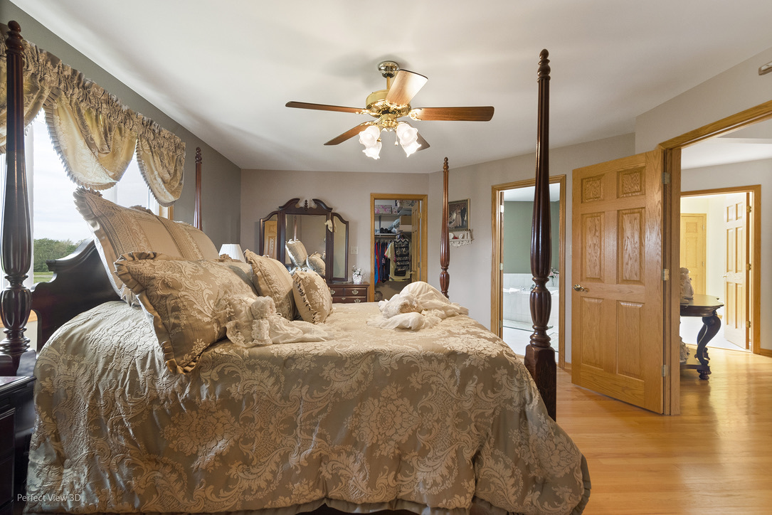 13836 West Joliet Road Manhattan, IL 60442 - Photo 16 of 25 a bed room with a bed and a chandelier