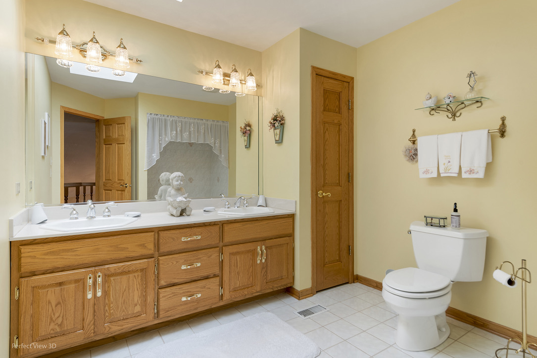13836 West Joliet Road Manhattan, IL 60442 - Photo 19 of 25 a bathroom with a granite countertop toilet sink and mirror
