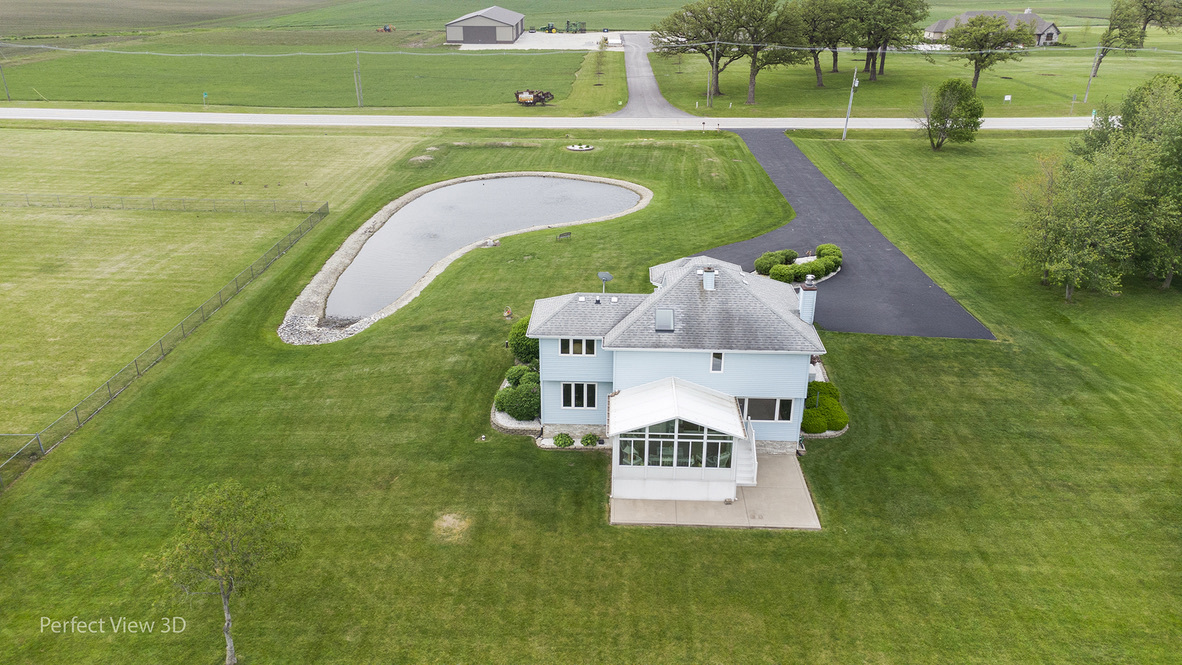 13836 West Joliet Road Manhattan, IL 60442 - Photo 25 of 25 a view of a table and chairs in the garden